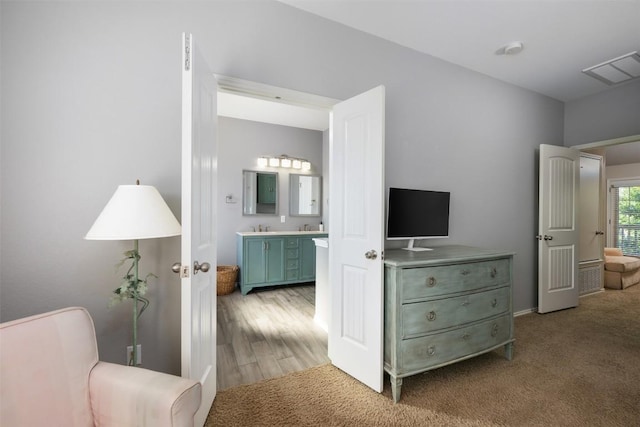 361 Stone View Trl, Austin, TX 78737 - bedroom with light carpet, a sink, and connected bathroom