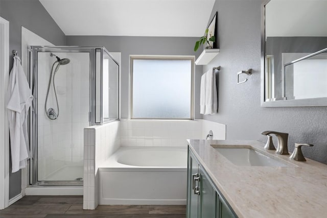 361 Stone View Trl, Austin, TX 78737 - full bathroom with a garden tub, a shower stall, vanity, and wood finished floors