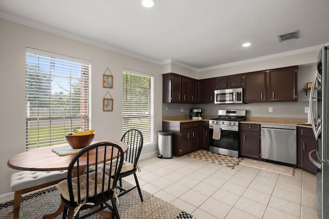 kitchen featuring stainless steel appliances, light countertops, dark brown cabinets, ornamental molding, and baseboards