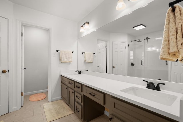 3312 Monument Dr, Round Rock, TX 78681 - bathroom with a stall shower, double vanity, tile patterned floors, and baseboards