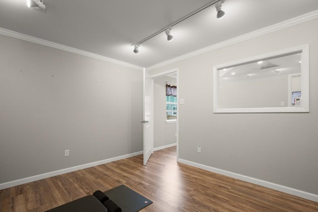 3312 Monument Dr, Round Rock, TX 78681 - empty room featuring rail lighting, wood finished floors, crown molding, and baseboards