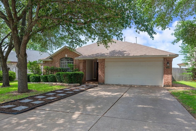single story home with brick siding, a garage, and driveway