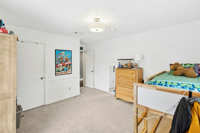 bedroom with carpet flooring and a textured ceiling