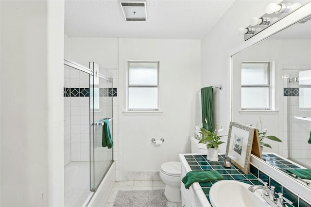 full bathroom featuring plenty of natural light, toilet, enclosed tub / shower combo, and baseboards