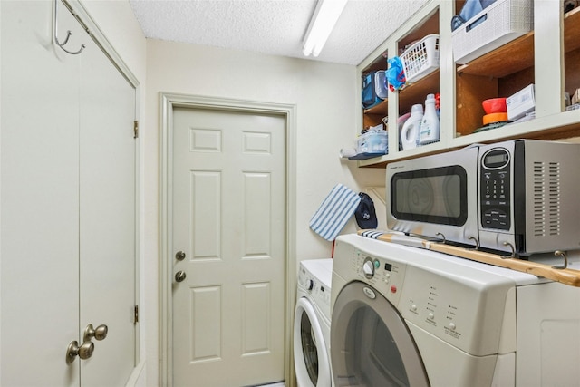 laundry area featuring independent washer and dryer and a textured ceiling