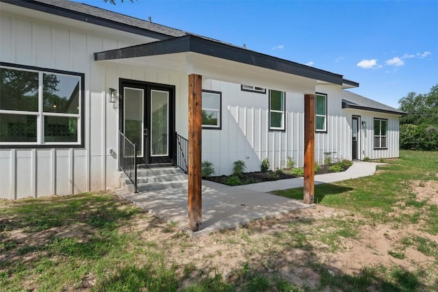 rear view of property with board and batten siding and a patio area