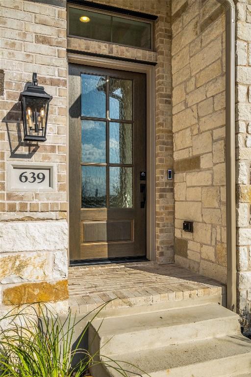 639 Bay Breeze Dr, Kyle, TX 78640 - view of exterior entry with brick siding and stone siding