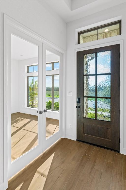 639 Bay Breeze Dr, Kyle, TX 78640 - entryway with french doors, wood finished floors, and healthy amount of natural light