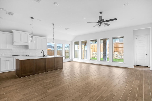 639 Bay Breeze Dr, Kyle, TX 78640 - kitchen with a sink, healthy amount of natural light, a ceiling fan, open floor plan, and vaulted ceiling
