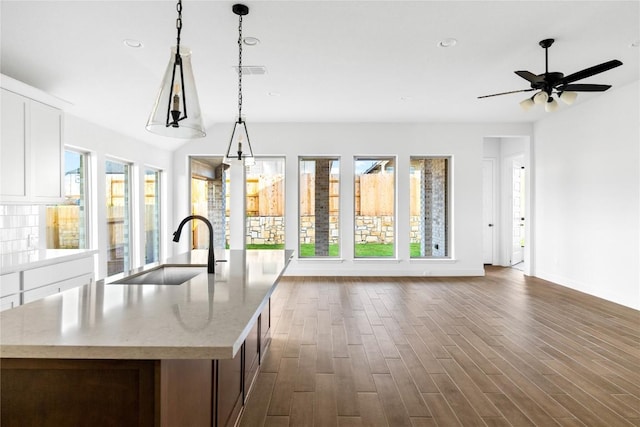 639 Bay Breeze Dr, Kyle, TX 78640 - kitchen featuring a sink, healthy amount of natural light, open floor plan, dark wood-style flooring, and recessed lighting