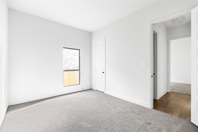 639 Bay Breeze Dr, Kyle, TX 78640 - unfurnished bedroom featuring carpet flooring, baseboards, and wood finished floors
