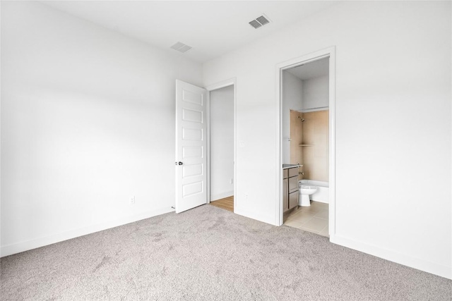 639 Bay Breeze Dr, Kyle, TX 78640 - unfurnished bedroom featuring light colored carpet and connected bathroom