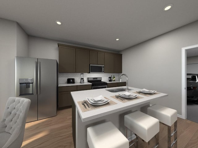 828 Sun Grove Trl, Georgetown, TX 78628 - kitchen with appliances with stainless steel finishes, a sink, decorative backsplash, light wood-style floors, and light countertops