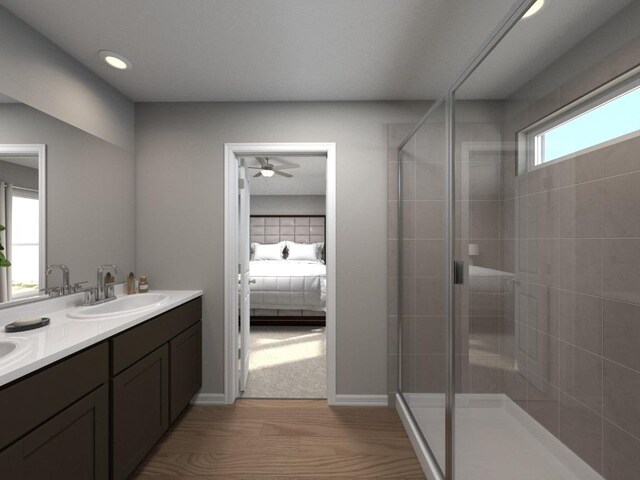 828 Sun Grove Trl, Georgetown, TX 78628 - ensuite bathroom featuring a stall shower, wood finished floors, double vanity, ceiling fan, and recessed lighting