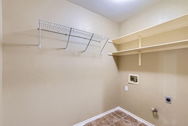 17904 Worley Dr, Pflugerville, TX 78660 - laundry area featuring hookup for a washing machine, hookup for an electric dryer, baseboards, dark tile patterned floors, and hookup for a gas dryer