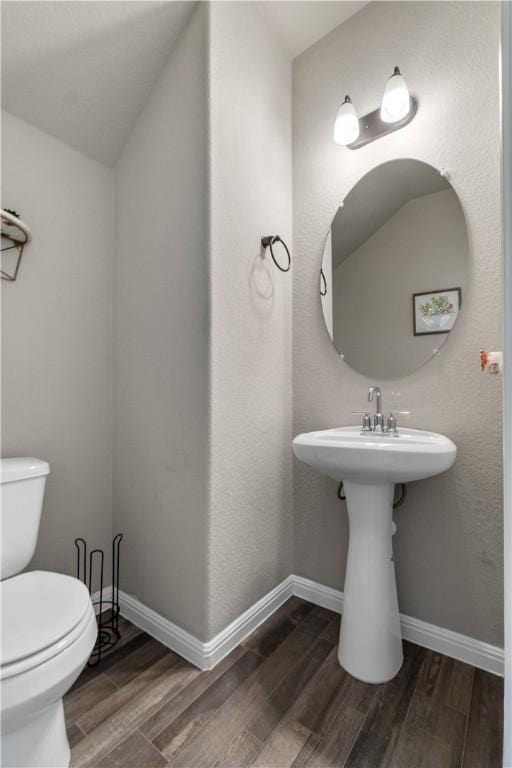 bathroom featuring wood finished floors, toilet, and baseboards