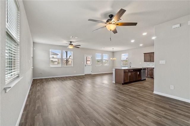 unfurnished living room with a sink, ceiling fan, dark wood-style floors, baseboards, and recessed lighting
