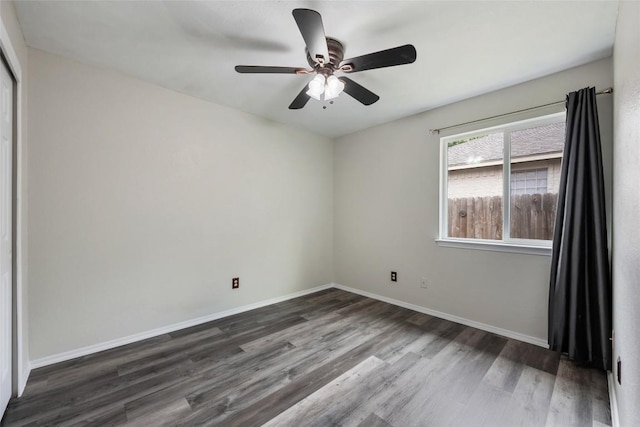 unfurnished room featuring wood finished floors, a ceiling fan, and baseboards