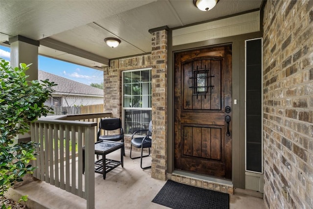 view of exterior entry with a porch