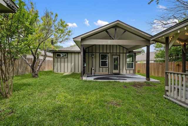 back of house featuring a patio area and board and batten siding