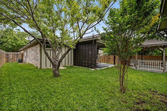 view of yard featuring mail area, central AC unit, and a gazebo