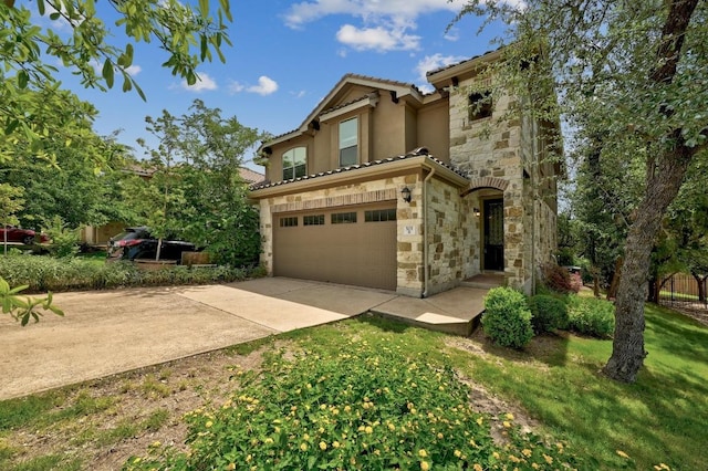 503 S Meadowlark St Unit B, Lakeway, TX 78734 - mediterranean / spanish-style house with stone siding, a tile roof, concrete driveway, a garage, and stucco siding