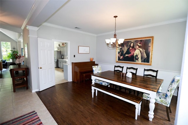 1401 Brixey Cv, Austin, TX 78754 - dining room featuring ornamental molding, a chandelier, decorative columns, and light wood-style flooring