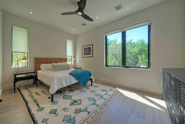 2309 S 4th St, Austin, TX 78704 - bedroom with light wood finished floors, multiple windows, baseboards, recessed lighting, and ceiling fan
