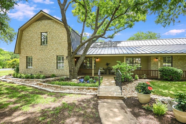 3301 Arrowhead Cir, Round Rock, TX 78681 - rear view of house with a porch, a standing seam roof, and stone siding