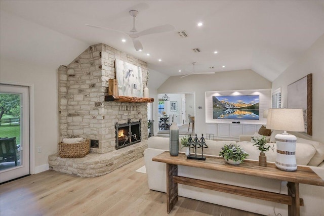 3301 Arrowhead Cir, Round Rock, TX 78681 - living room featuring lofted ceiling, a ceiling fan, light wood-style floors, and a fireplace