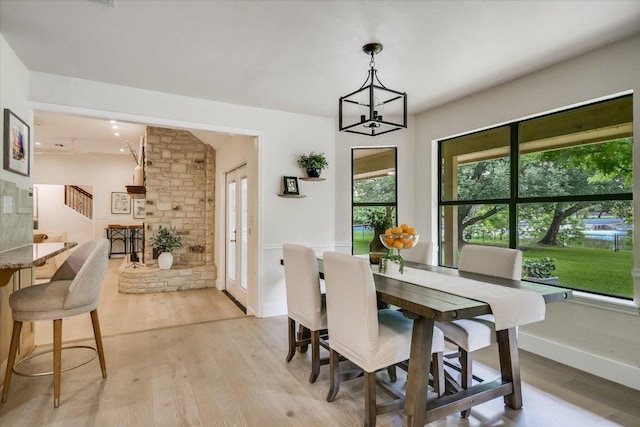 3301 Arrowhead Cir, Round Rock, TX 78681 - dining area with stairway, light wood finished floors, and a chandelier