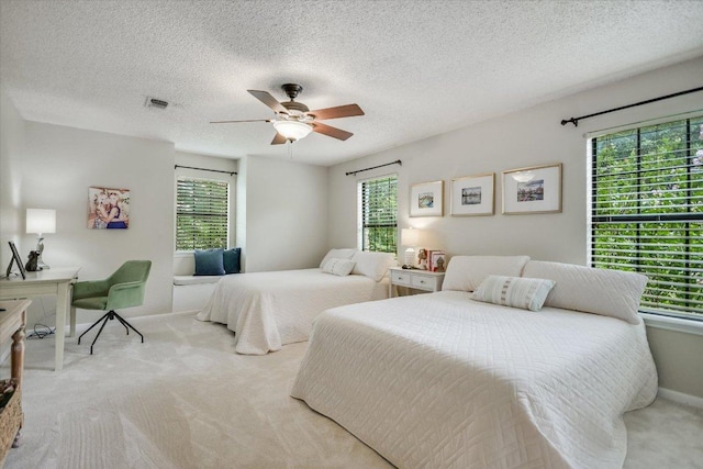 3301 Arrowhead Cir, Round Rock, TX 78681 - carpeted bedroom featuring multiple windows, ceiling fan, and a textured ceiling