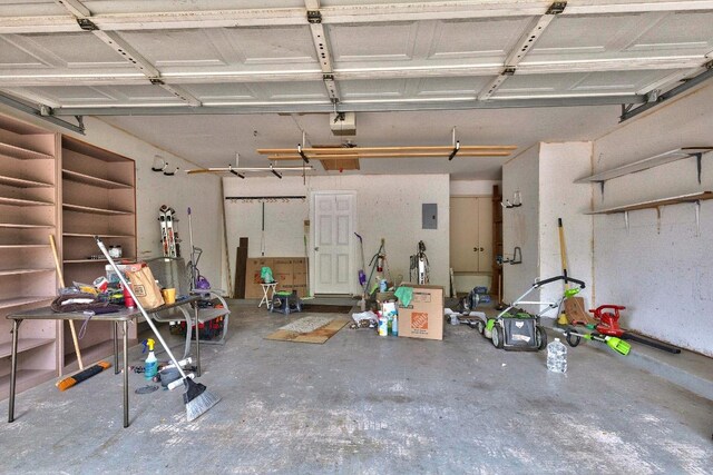 13269 Kerrville Folkway, Austin, TX 78729 - garage featuring electric panel and a garage door opener