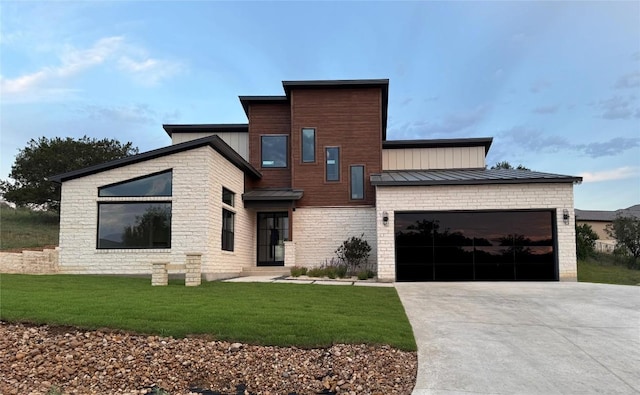 3318 Bay W Blvd, Horseshoe Bay, TX 78657 - modern home with a standing seam roof, driveway, an attached garage, a front yard, and metal roof