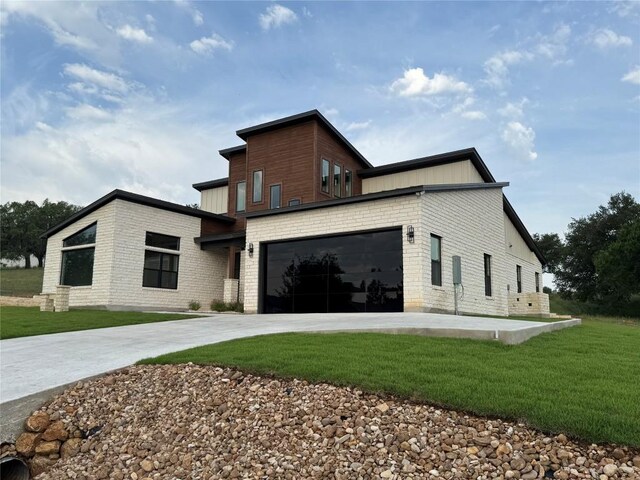 3318 Bay W Blvd, Horseshoe Bay, TX 78657 - view of property exterior featuring driveway, a yard, and a garage