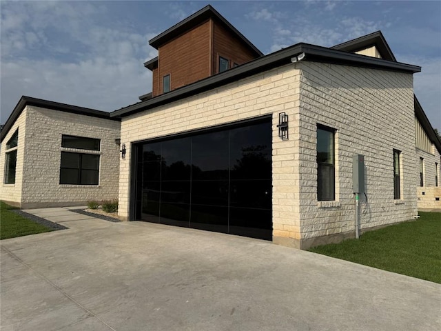 3318 Bay W Blvd, Horseshoe Bay, TX 78657 - view of property exterior featuring driveway, a garage, and brick siding