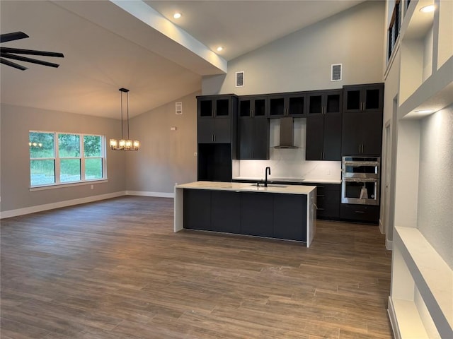 3318 Bay W Blvd, Horseshoe Bay, TX 78657 - kitchen featuring dark cabinetry, stainless steel double oven, light countertops, a chandelier, and high vaulted ceiling