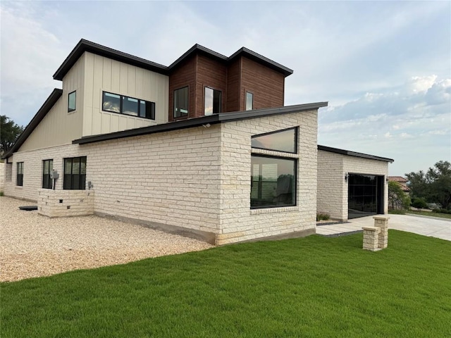 3318 Bay W Blvd, Horseshoe Bay, TX 78657 - view of property exterior featuring driveway, a lawn, an attached garage, and brick siding