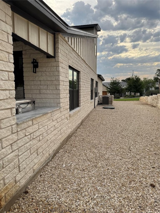 3318 Bay W Blvd, Horseshoe Bay, TX 78657 - view of side of home with brick siding and a central air condition unit
