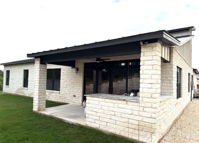 3318 Bay W Blvd, Horseshoe Bay, TX 78657 - back of property featuring a lawn, a patio, and a ceiling fan
