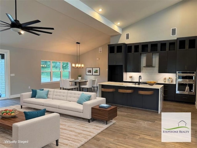 3318 Bay W Blvd, Horseshoe Bay, TX 78657 - living area with wood finished floors, high vaulted ceiling, ceiling fan, a chandelier, and recessed lighting