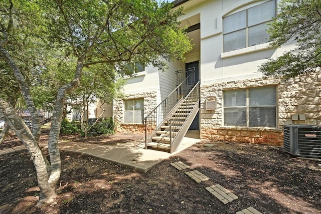 6000 Shepherd Mountain Cv Unit 107, Austin, TX 78730 - property entrance featuring central AC and stone siding