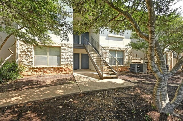 6000 Shepherd Mountain Cv Unit 107, Austin, TX 78730 - view of front of house featuring stairs, a patio, and stone siding