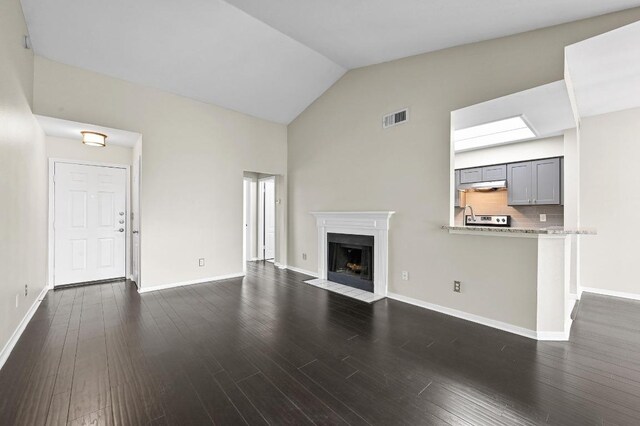 6000 Shepherd Mountain Cv Unit 107, Austin, TX 78730 - unfurnished living room with a fireplace with flush hearth, dark wood-style floors, and high vaulted ceiling