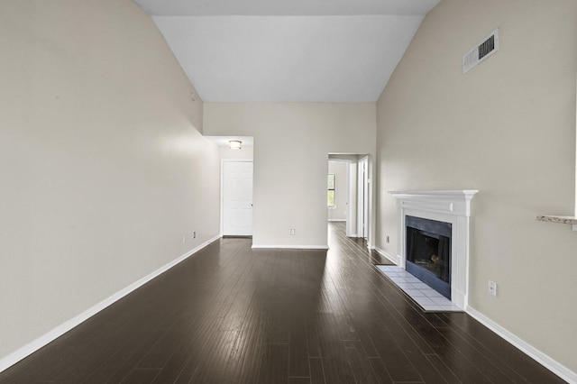 6000 Shepherd Mountain Cv Unit 107, Austin, TX 78730 - unfurnished living room featuring a fireplace, baseboards, dark wood-type flooring, and high vaulted ceiling