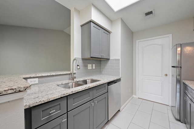 6000 Shepherd Mountain Cv Unit 107, Austin, TX 78730 - kitchen with stainless steel appliances, gray cabinets, light stone countertops, and tasteful backsplash