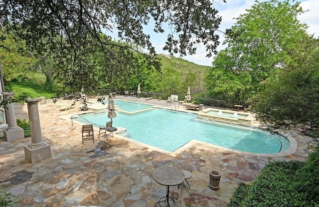 6000 Shepherd Mountain Cv Unit 107, Austin, TX 78730 - view of swimming pool with a patio area, fence, and a pool with connected hot tub