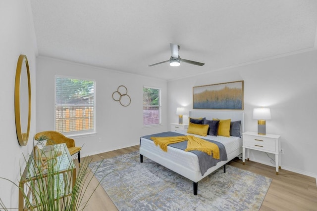 bedroom featuring wood finished floors, ceiling fan, and baseboards