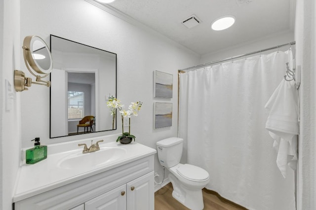 5901 Jacob Gln, Austin, TX 78727 - full bathroom featuring vanity, toilet, and wood finished floors