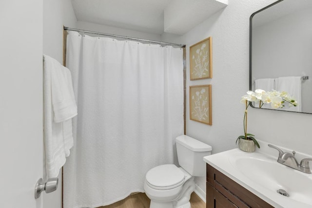 5901 Jacob Gln, Austin, TX 78727 - bathroom featuring vanity, toilet, wood finished floors, and a shower with curtain
